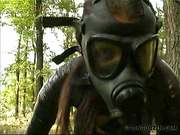 Victim in plastic wrap and gasmask punished outdoors